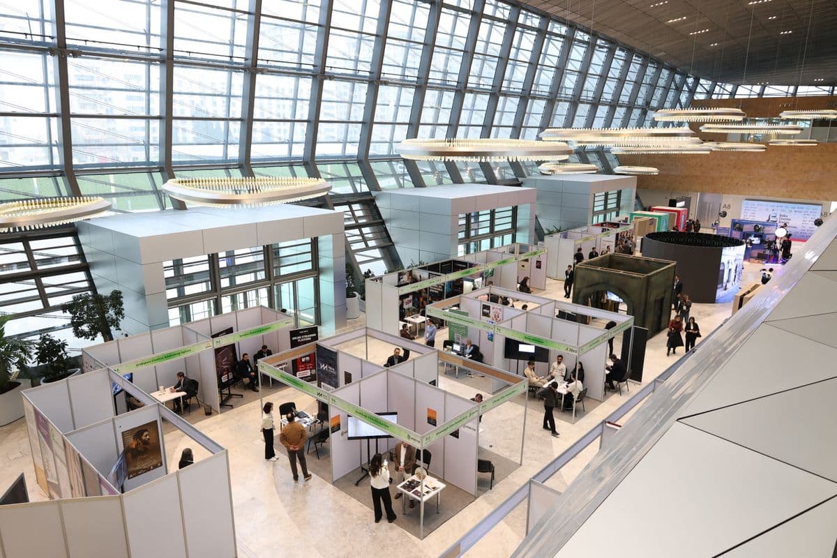 Bright international exhibition hall with visitors and trade show booths
